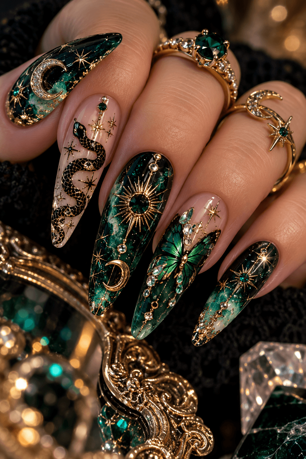 Emerald green celestial nails with gold moons, snakes and gemstones